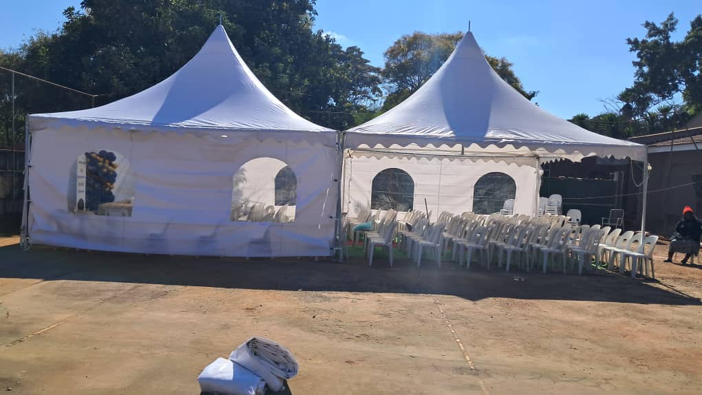 Marquee tents with chairs set up for a funeral function