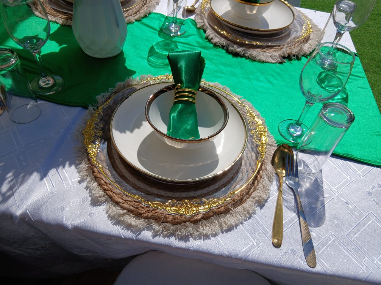 Close-up of gold and green place setting with fine china